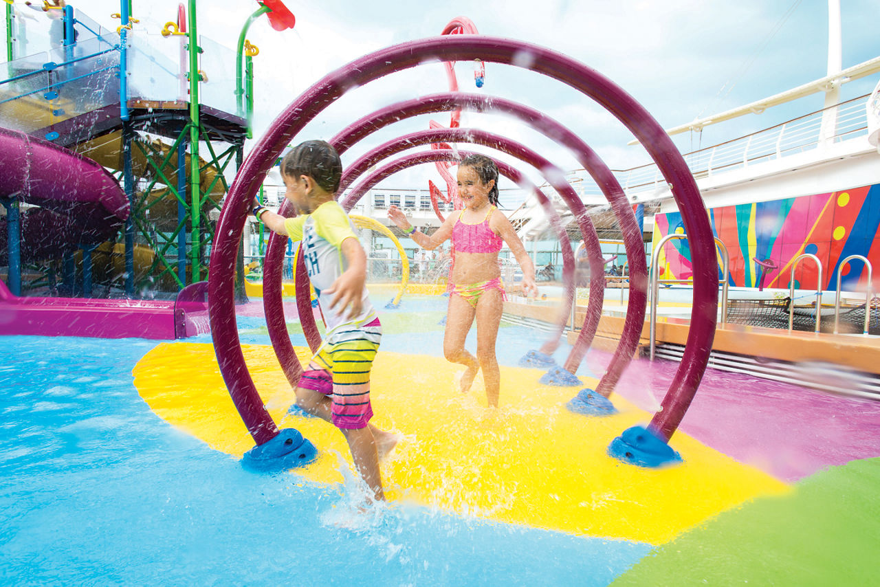 LB, Liberty of the Seas, two kids, children, little boy, girl, playing in Splashaway Bay aqua park, splashing in water, running, fun, smiling,