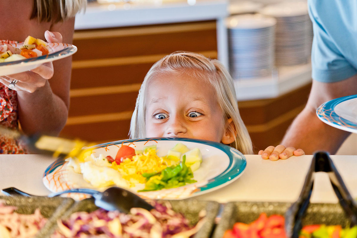 Girl looking at food part of the My Family Time cruise dining experience for kids.