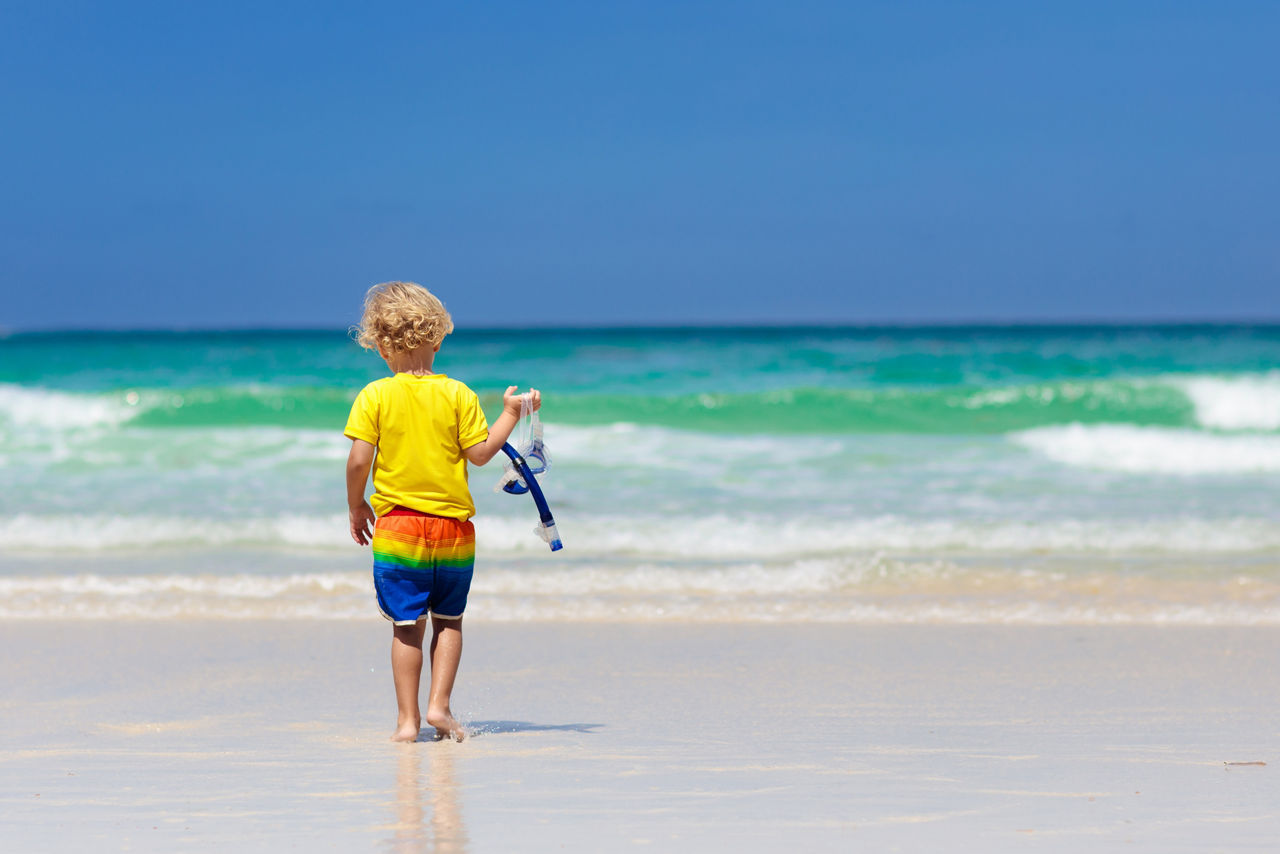 Child snorkeling on tropical beach. Kids snorkel.