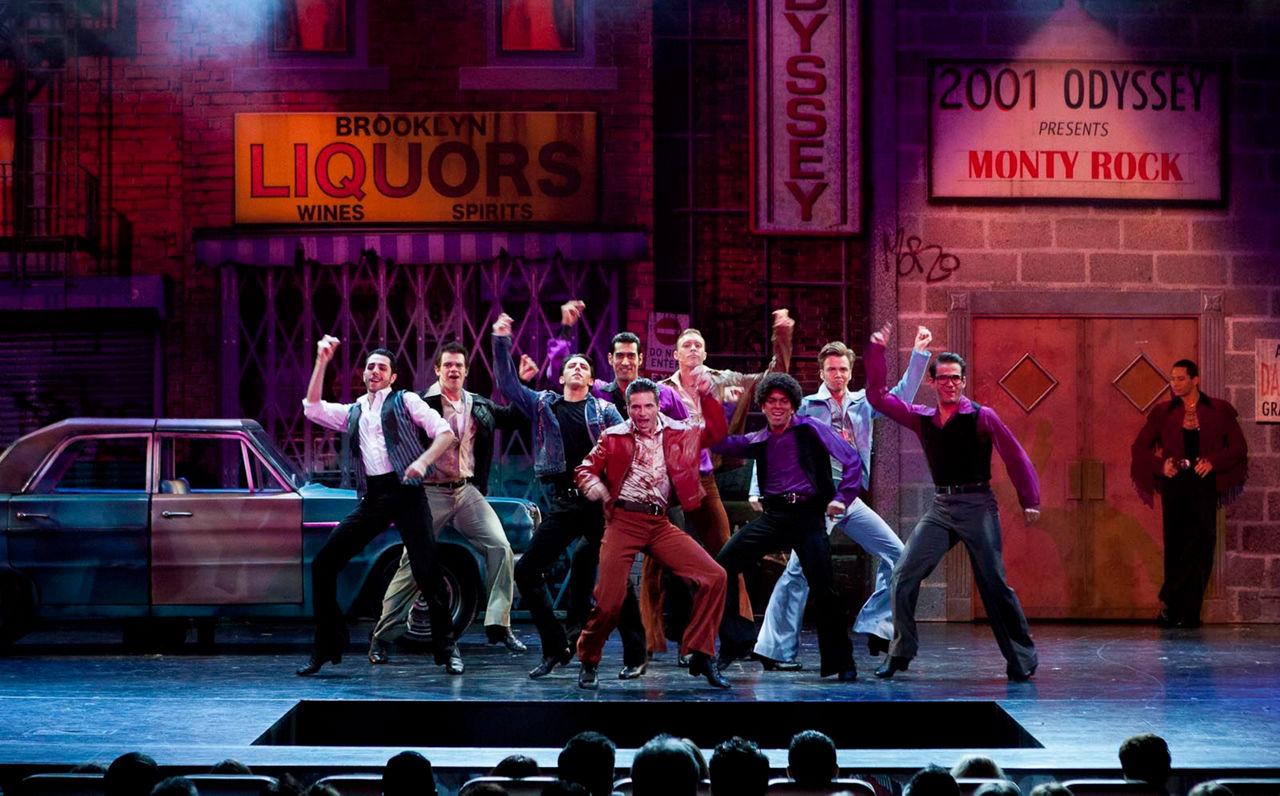 Men dancing on main stage during Saturday Night Fever Broadway show on Liberty.