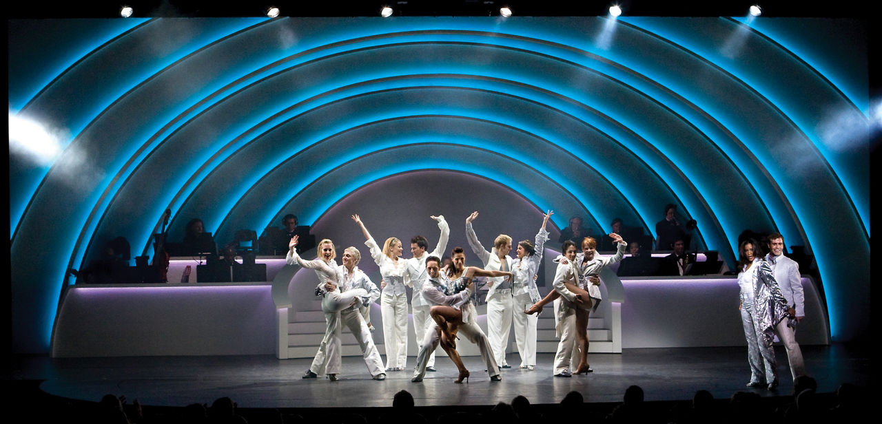 Center Stage Cruise Show Performers in White on Stage Brilliance of the Seas