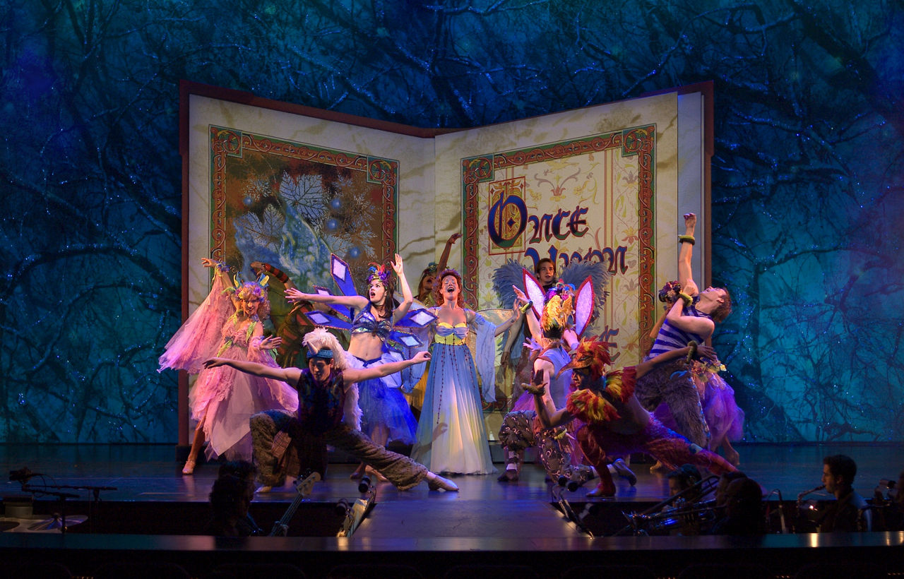 Freedom of the Once Upon a Time Cruise Show, Performers on Stage With A book Behind them