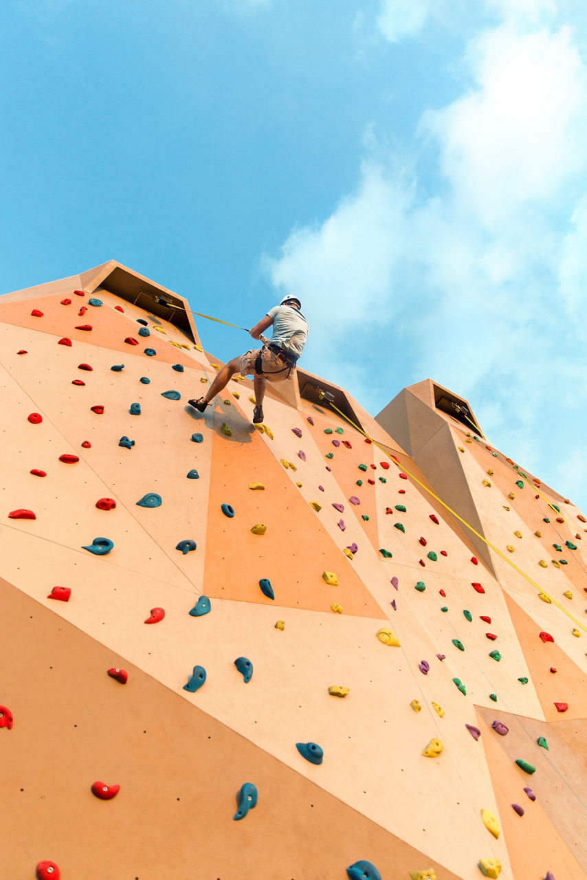 Man Arrive on the top of the Rock Wall 