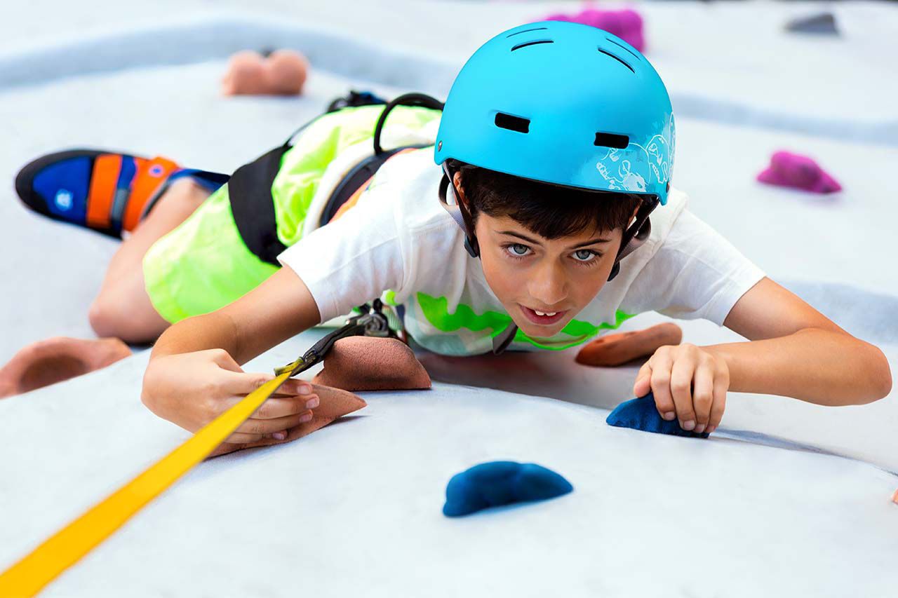 Young Boy Climbing Rock