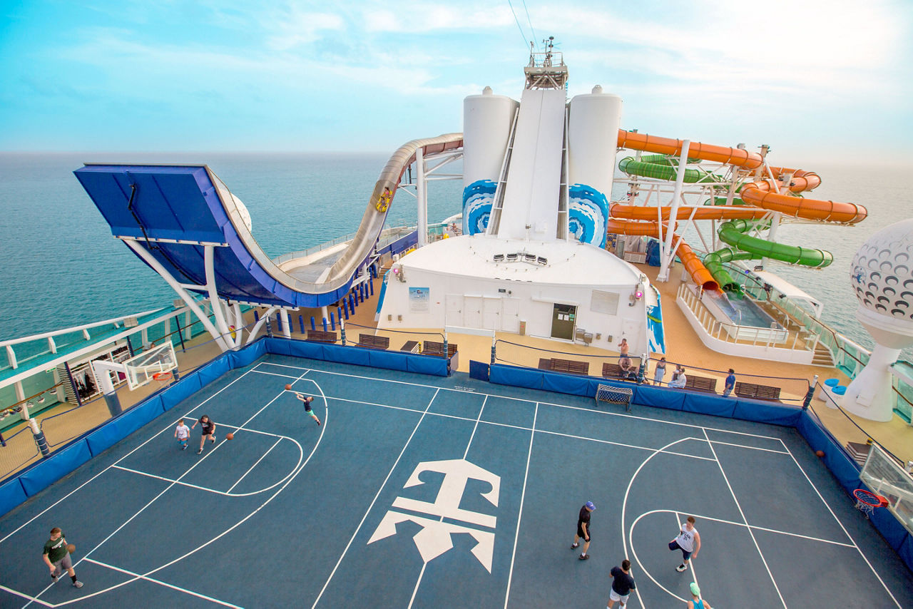 Men Playing Basketball in the Sports Court  with Tidal Wave in the Background