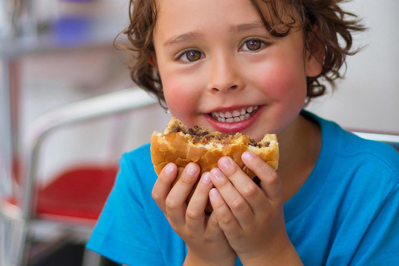 Johnny Rockets Kid Eating Hamburger