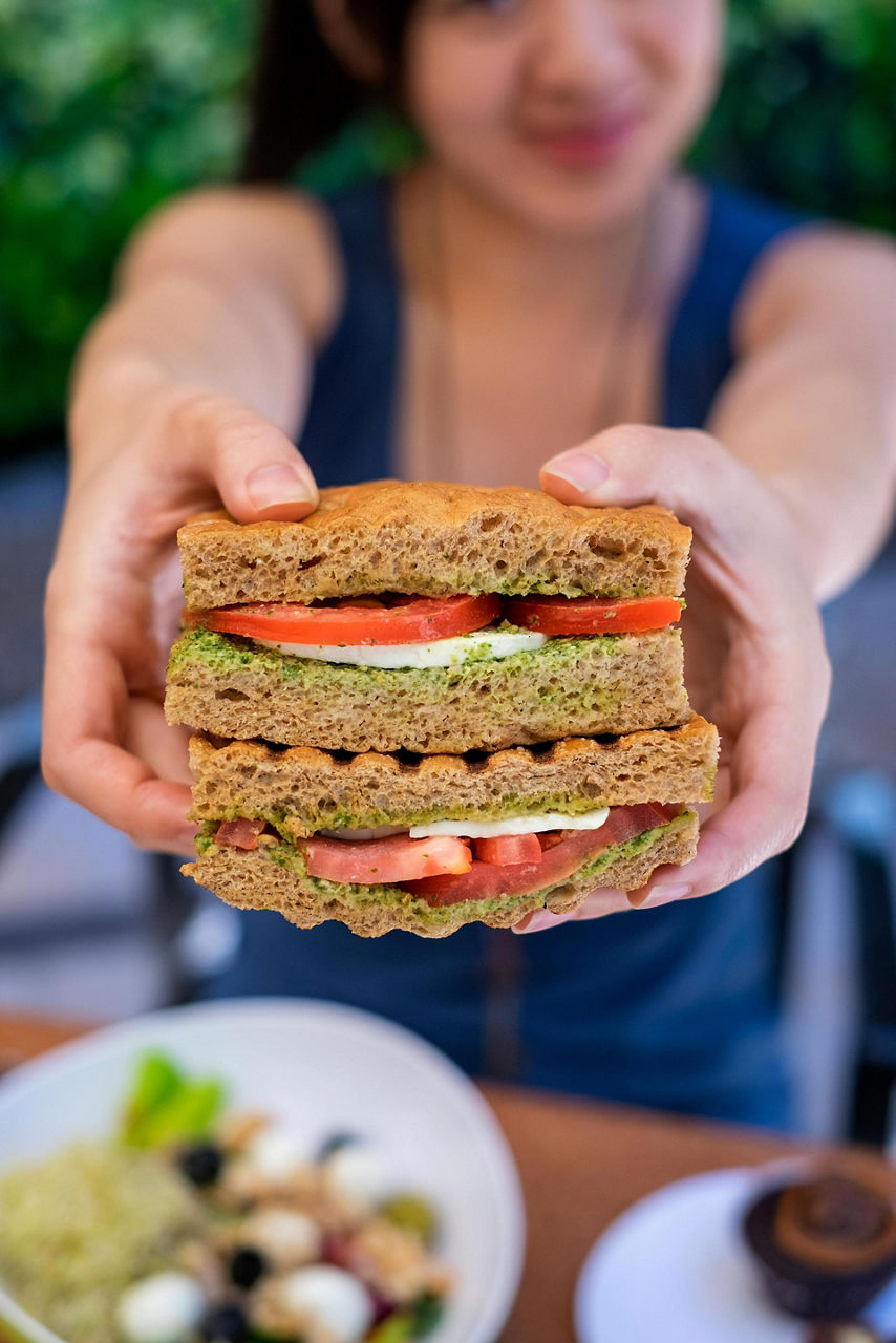 Park Cafe A Woman Holding a Sandwich