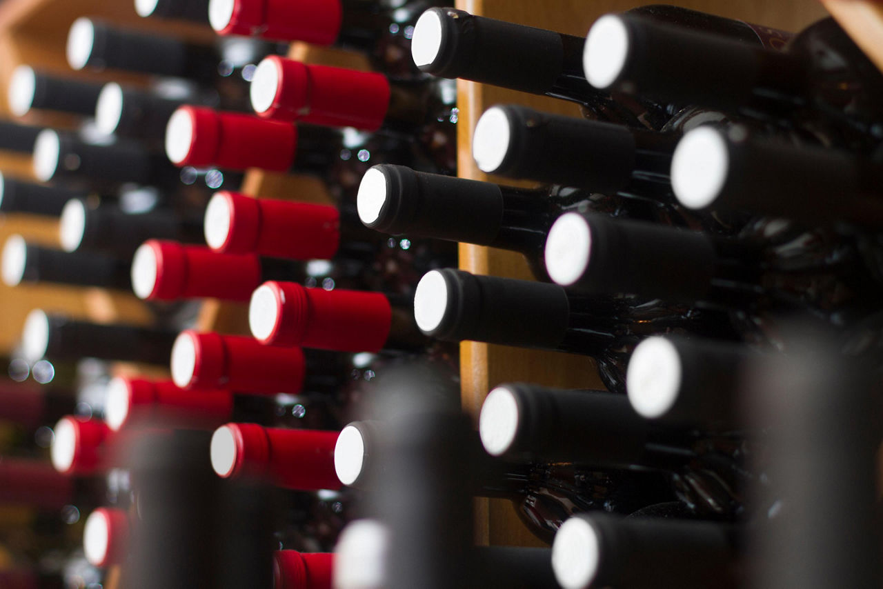 Wine bottles arranged on the wall of a shop in Argostoli, Greece