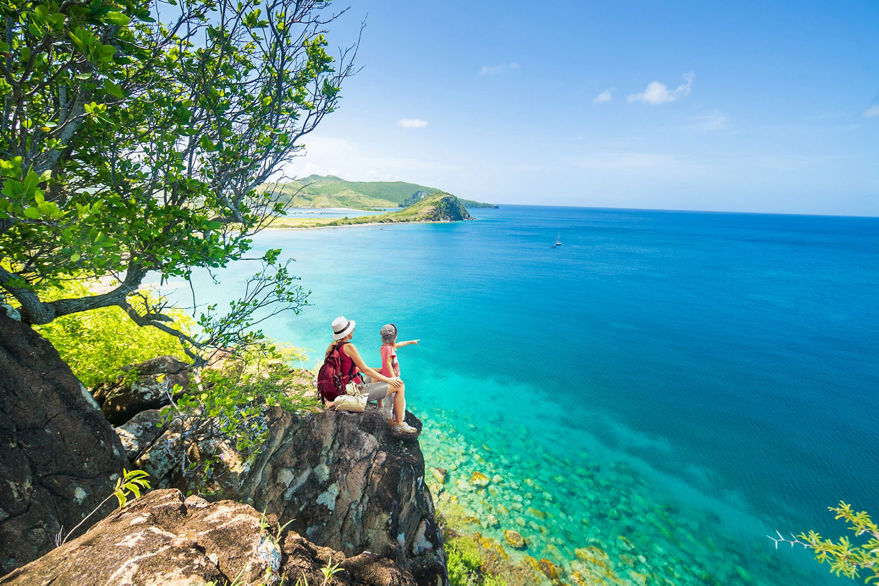 Family Sitting by the Coast. Basseterre, St. Kitts Nevis 