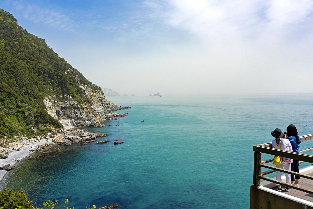 Two women looking at the sea from Taejongdae lighthouse observatory in Busan, South Korea