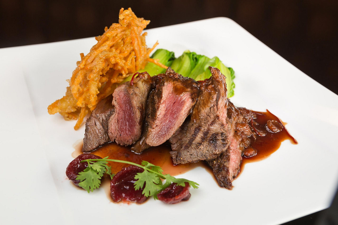 A grilled Kangaroo steak on a white plate