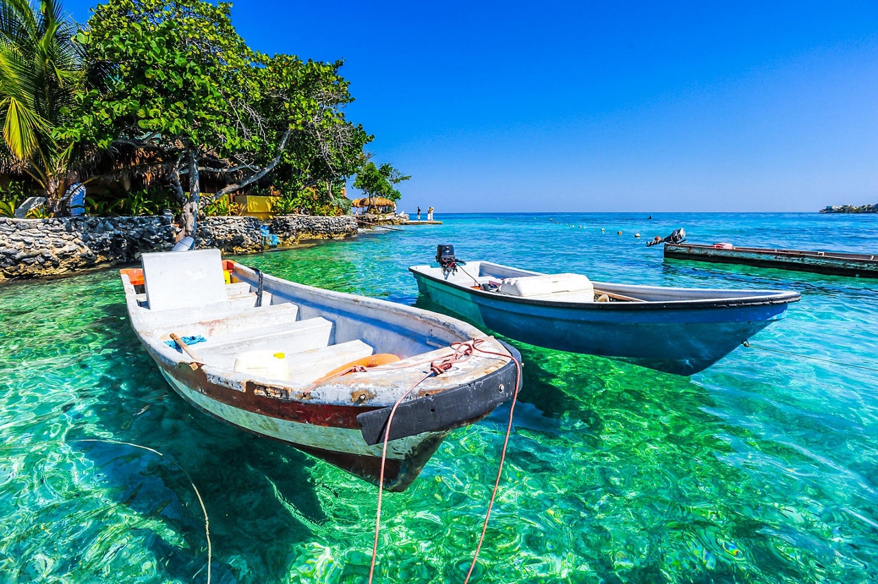 Small boats anchored close to shore at Islas de Roasario, Colombia