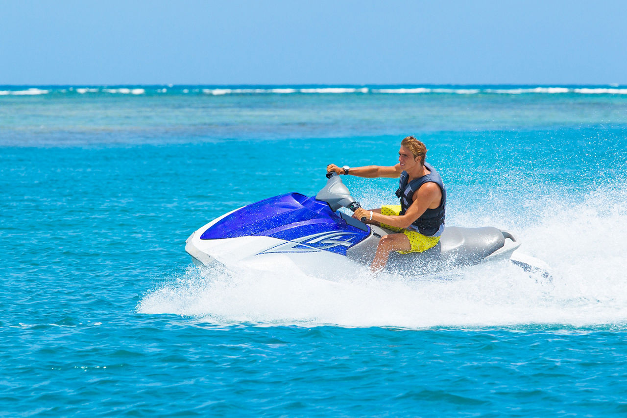 Man Riding Jet Ski in Beautiful Blue Water, Coco Cay, Bahamas