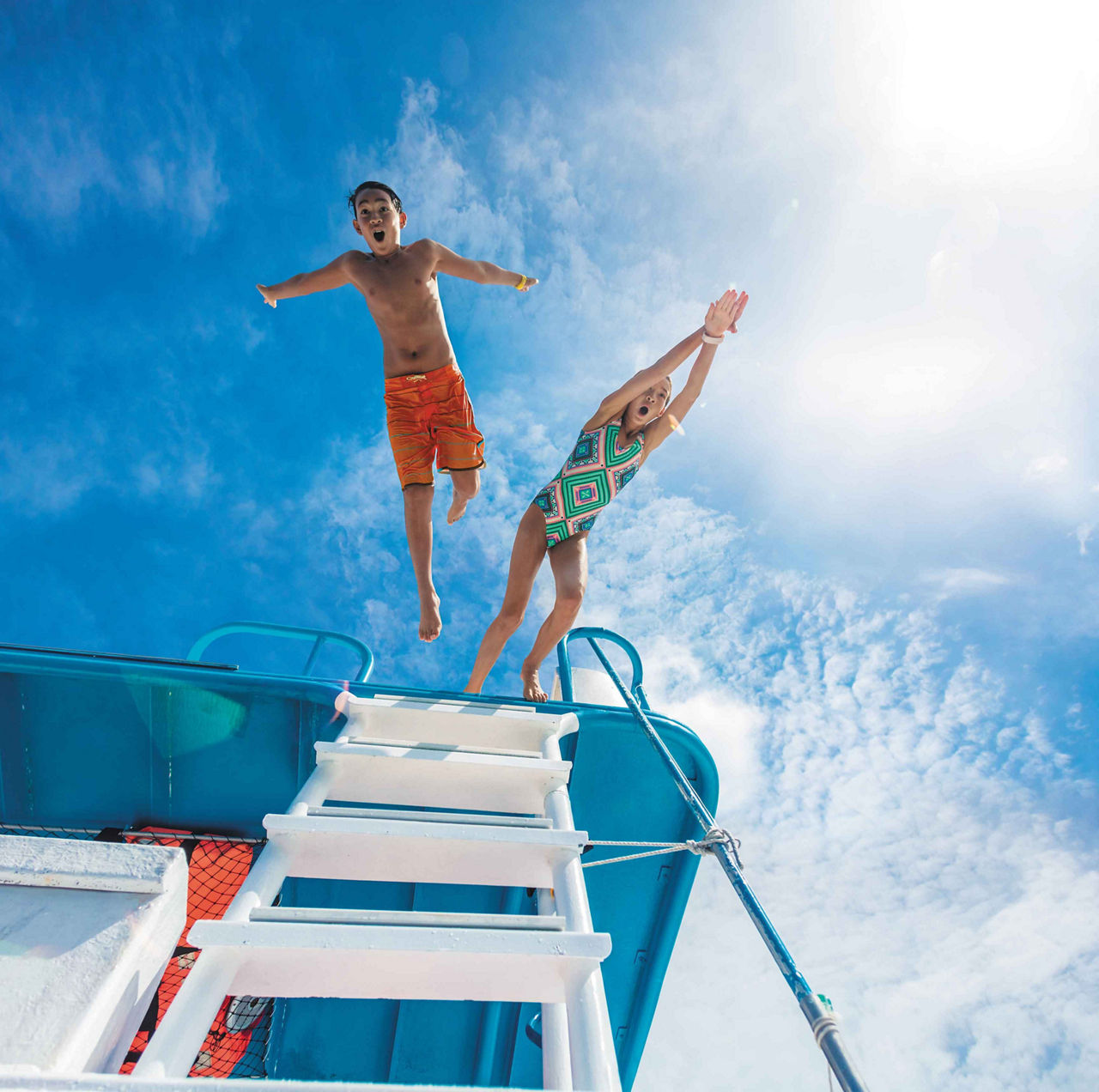 Kids Jumping off a Boat into the Ocean, Cozumel, Mexico 