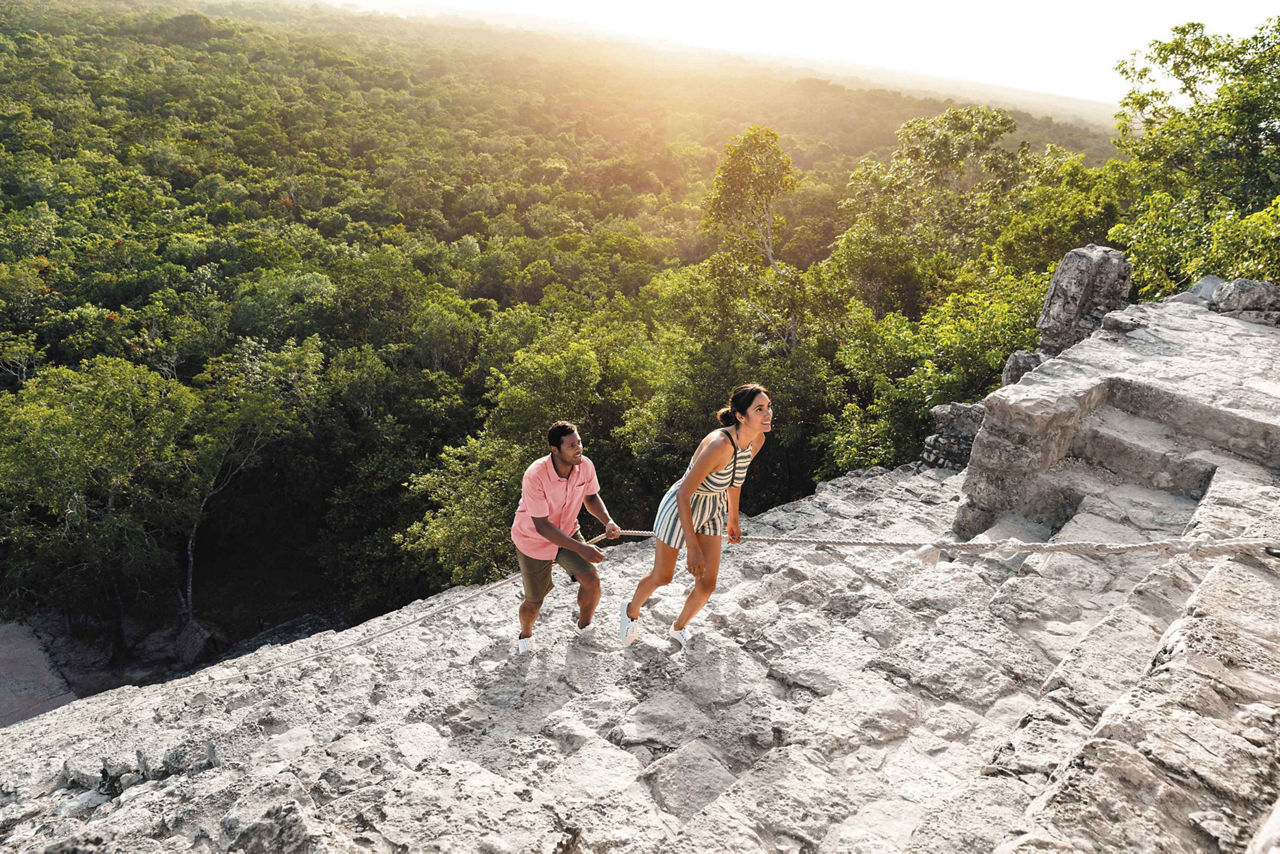 Couple Climbing up the Ruins Pyramid, Cozumel, Mexico 