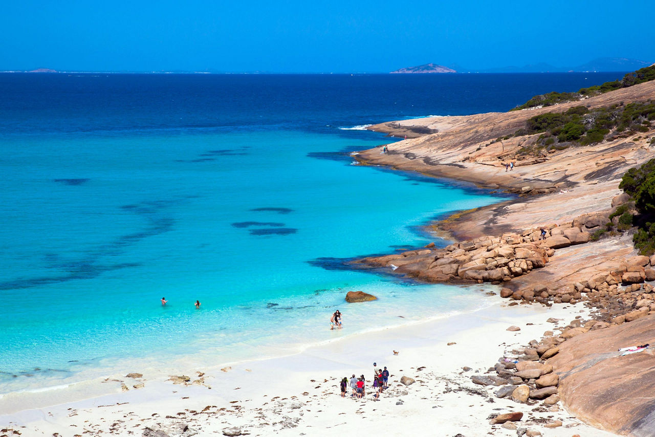 A small group standing on the sand at Blue Haven beach in Esperance, Australia