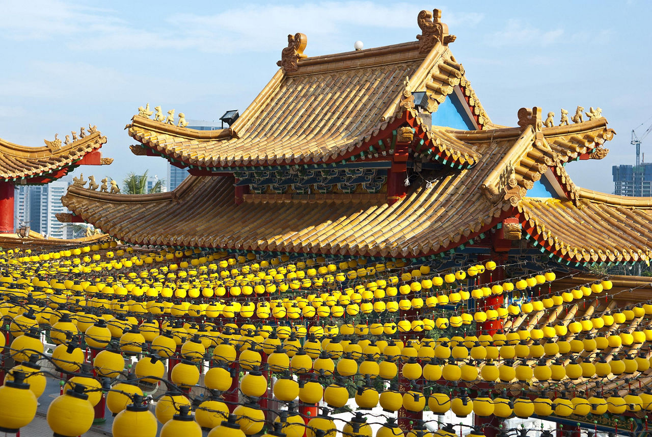 Yellow lanterns hanging on the roof of the temple in Kuala Lumpur, Malaysia