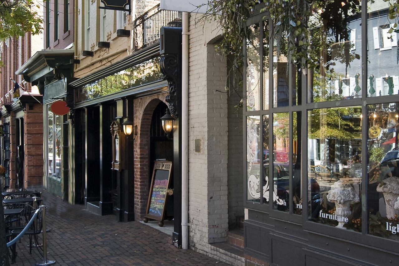 Various storefronts on a brick street