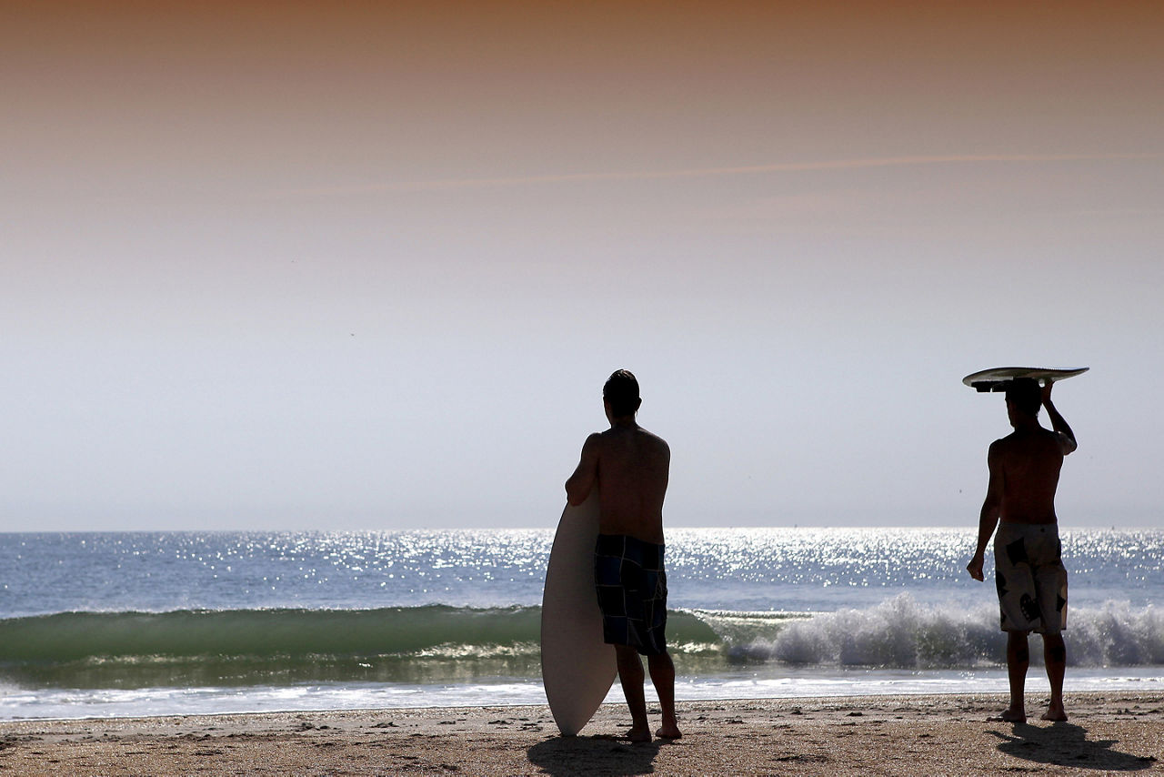 Surfer's Standing By Wavy Cocoa Beach, Cape Canaveral, Florida