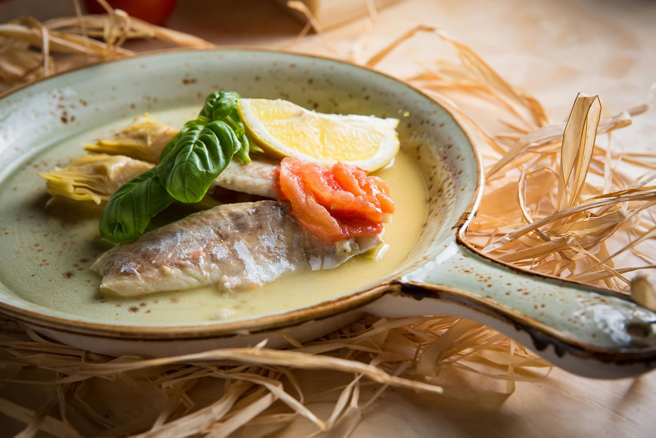 A fish fillet served with artichokes