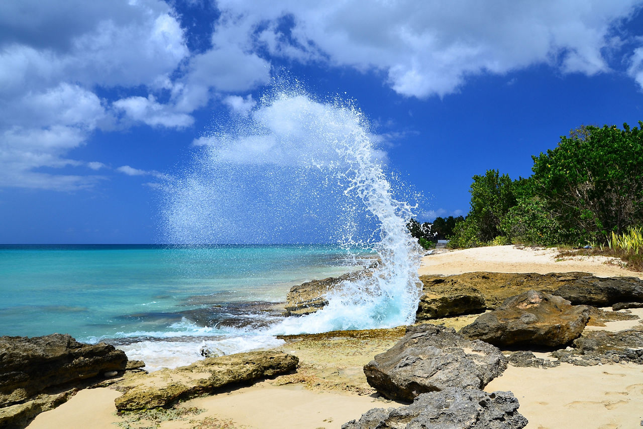 Wave Crashing Against Rocks on a Sunny Day in Frederiksted Beach, St. Croix, U.S. Virgin Islands