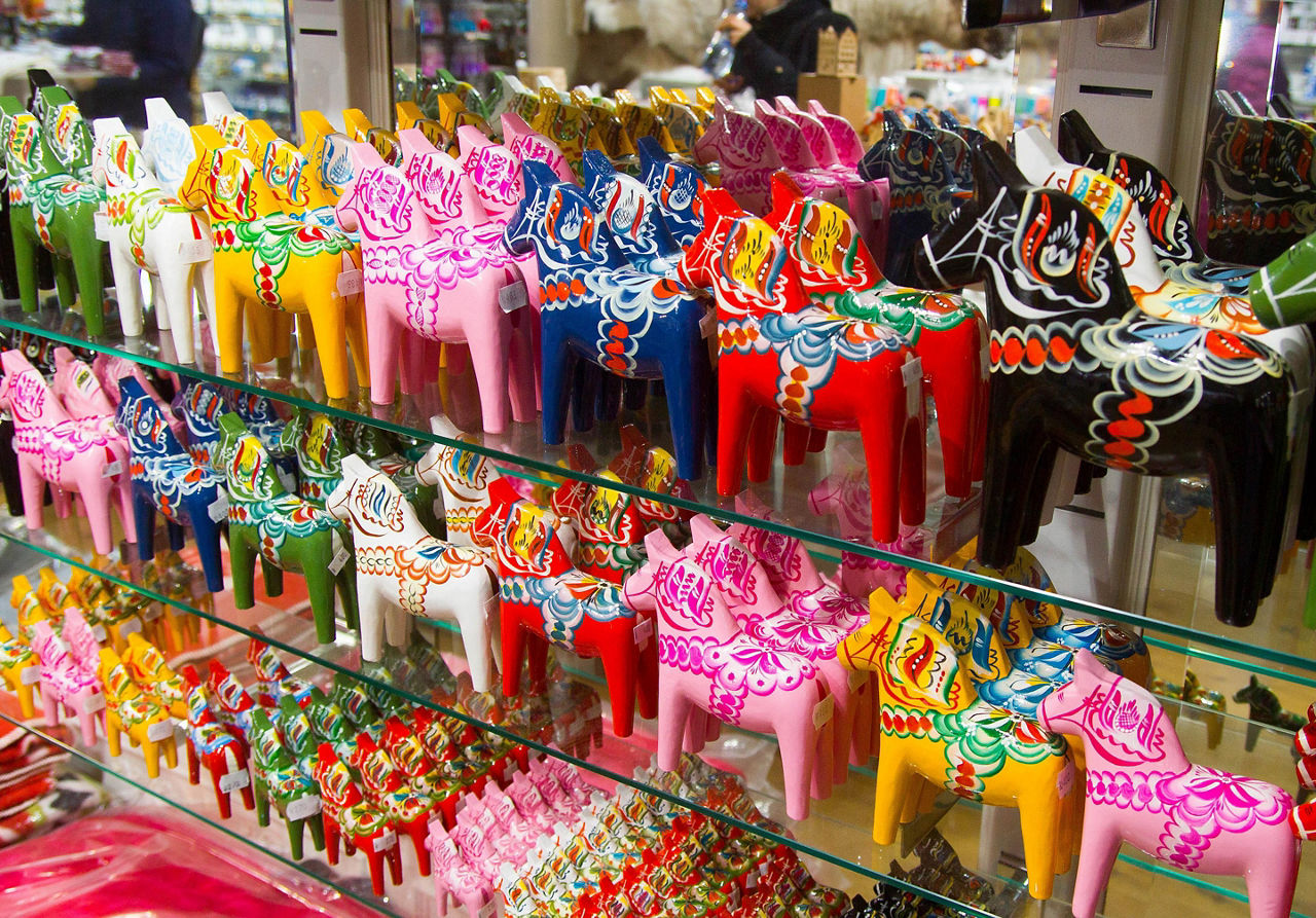An assortment of colorful toy horses for sale in Sweden
