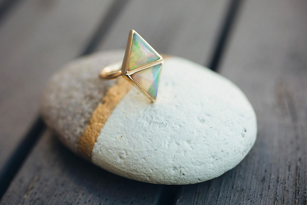 An opal ring displayed on a stone