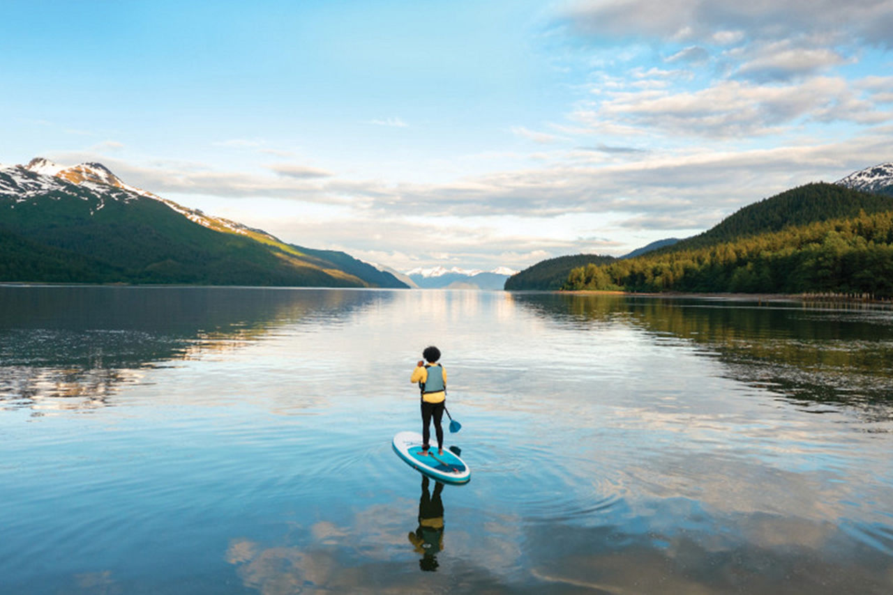 Woman Paddle Boarding Through the Mountains, Juneau, Alaska