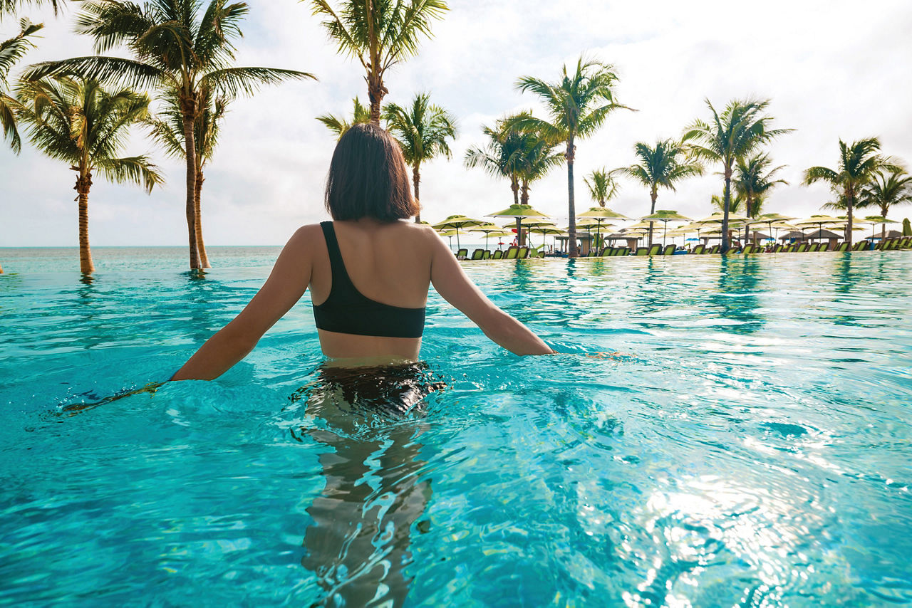 Coco Beach Club Woman Swimming Infinity Pool, Perfect Day at Coco Cay