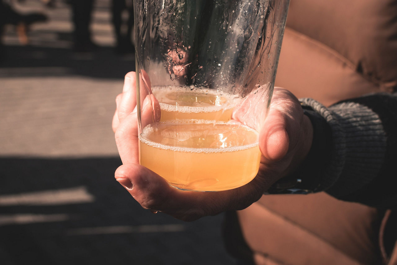 Man Offering Fresh Glass of Spanish Cider