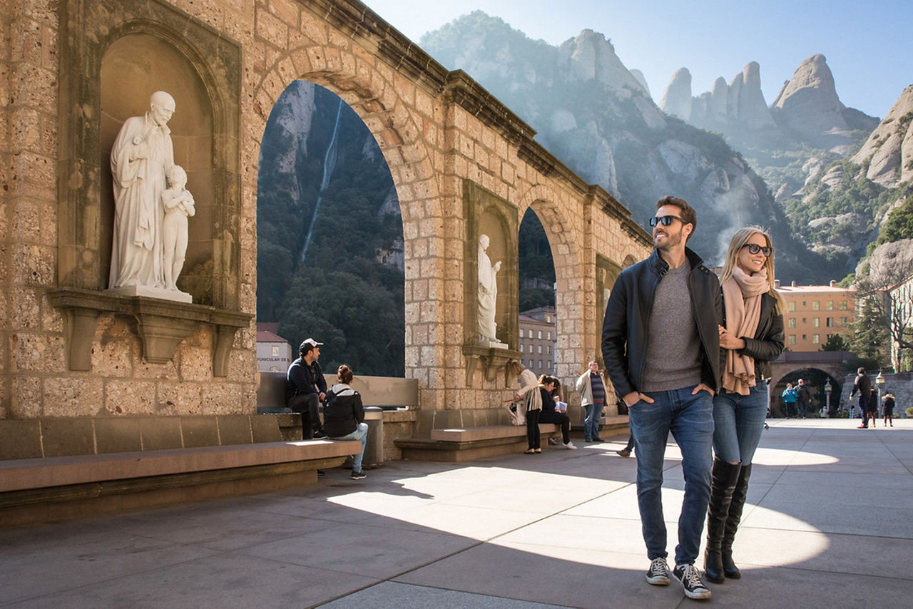 Spain Montserrat Couple Walking Across Historical Street