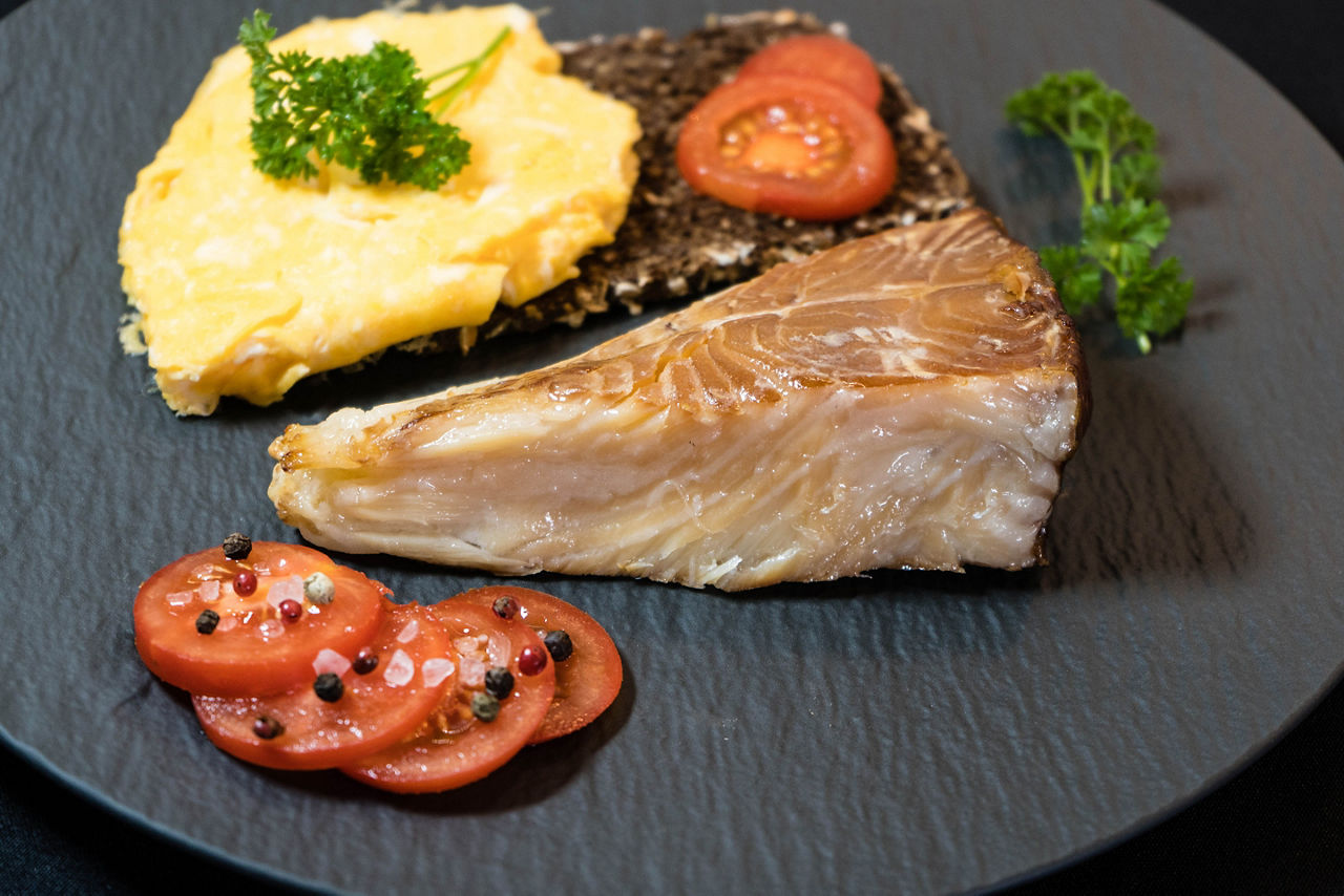 Smoked greenland halibut with tomato salad bread and eggs