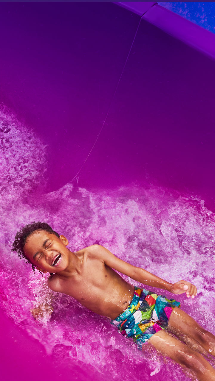 Kid Water Sliding in Purple Waterslider HP Jumbotron 1920 1080 FAM NF 2x