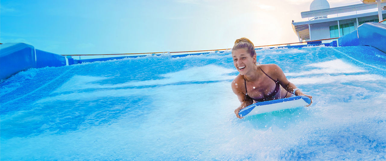 Lady riding bodyboard in Flowrider  | HP