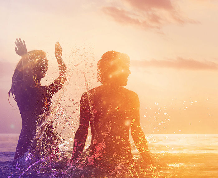 Couple Splashing in the Ocean 