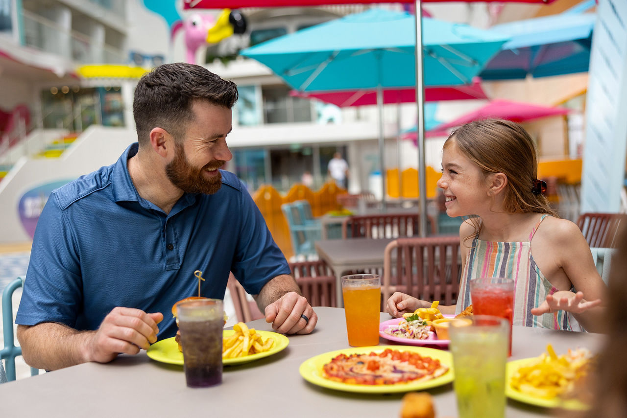 Icon of the Seas Father and Daughter Enjoying Lunch at Surfside Eatery