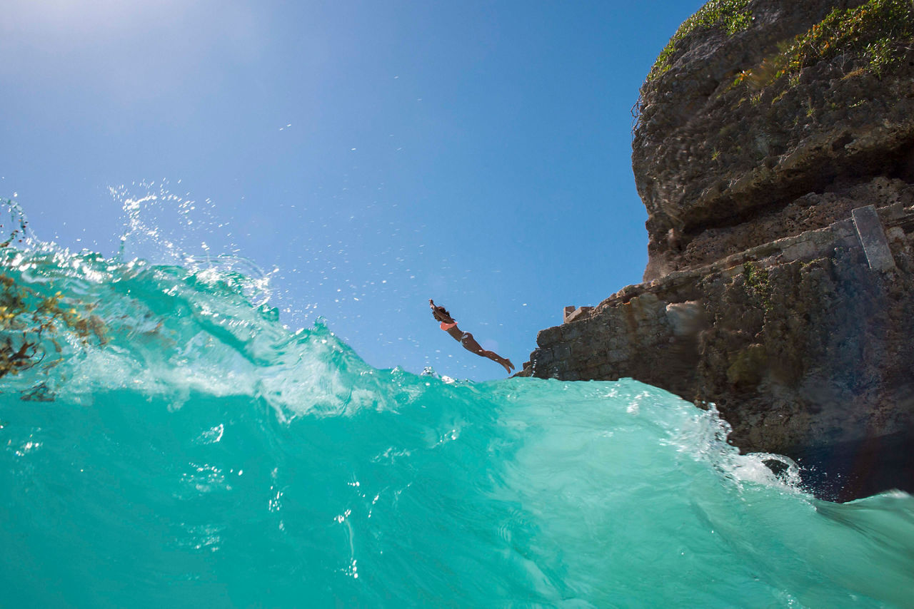 Woman Cliff Diving to the Ocean, Barbados