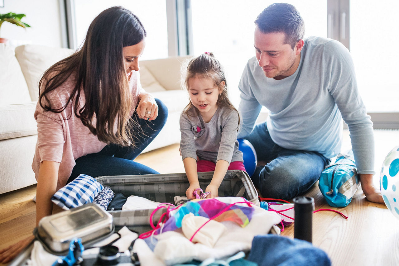 Young Family with a Child Packing for Holiday