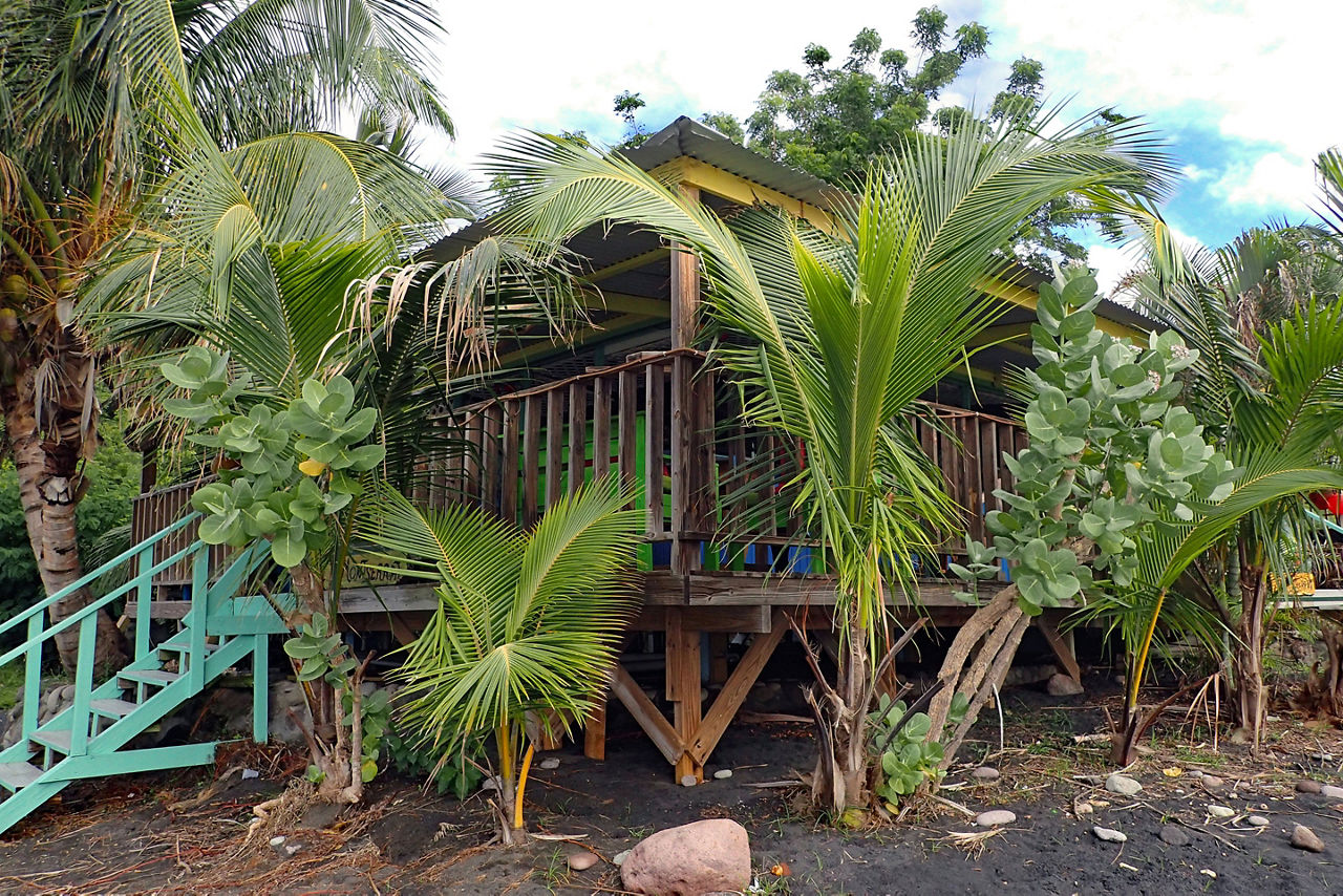 rustic wooden beach home with turquoise stairs. The Caribbean.