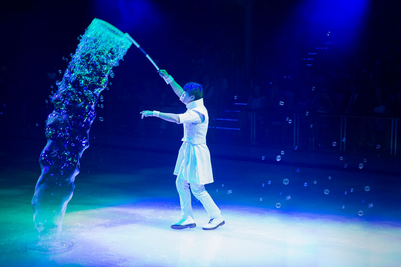 A man creating bubbles on the ice during the 1887 Ice Skating show.