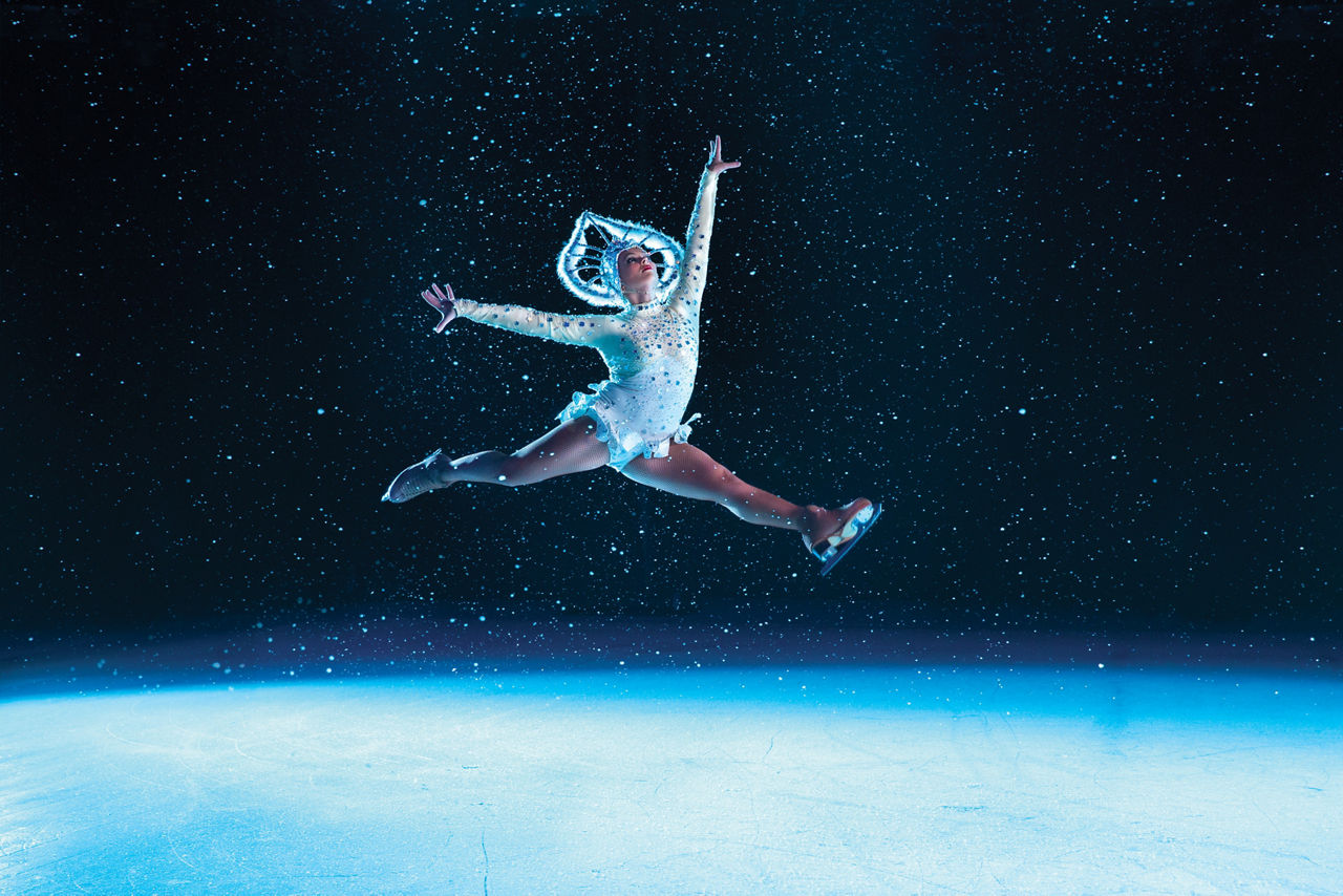 Women performer jumping during ice skating shows onboard a cruise.