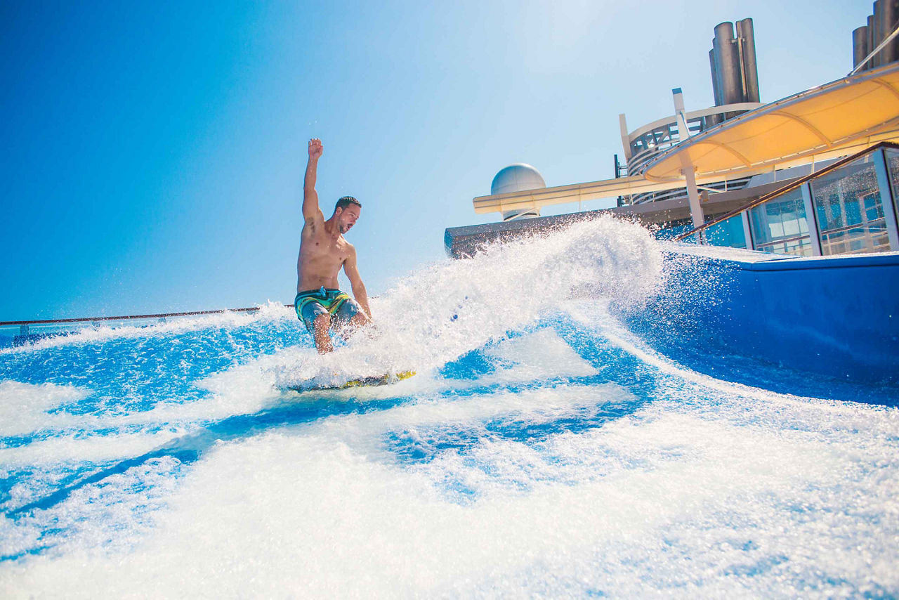 Man Splashing and Surfing on Flowrider 