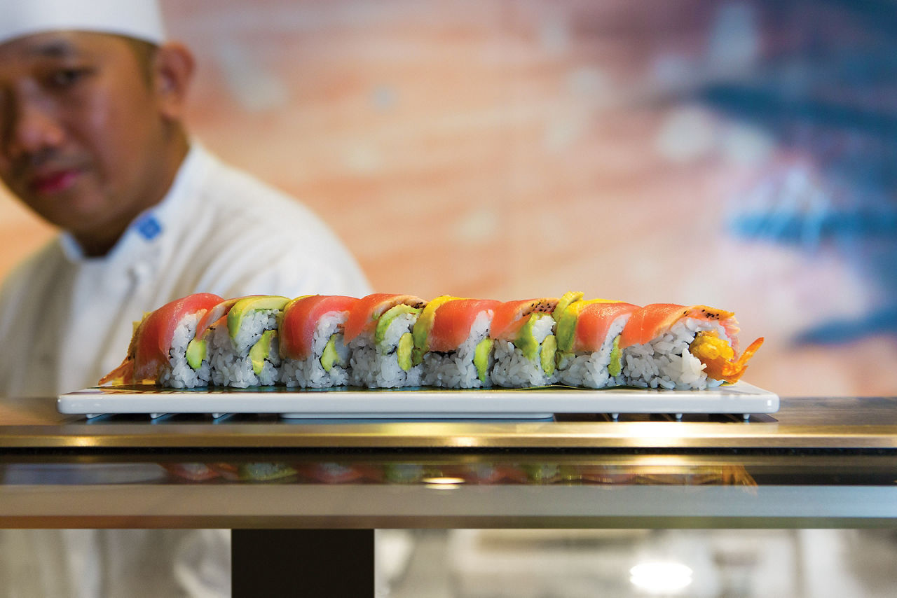 Sushi Chef Serving a Salmon Roll