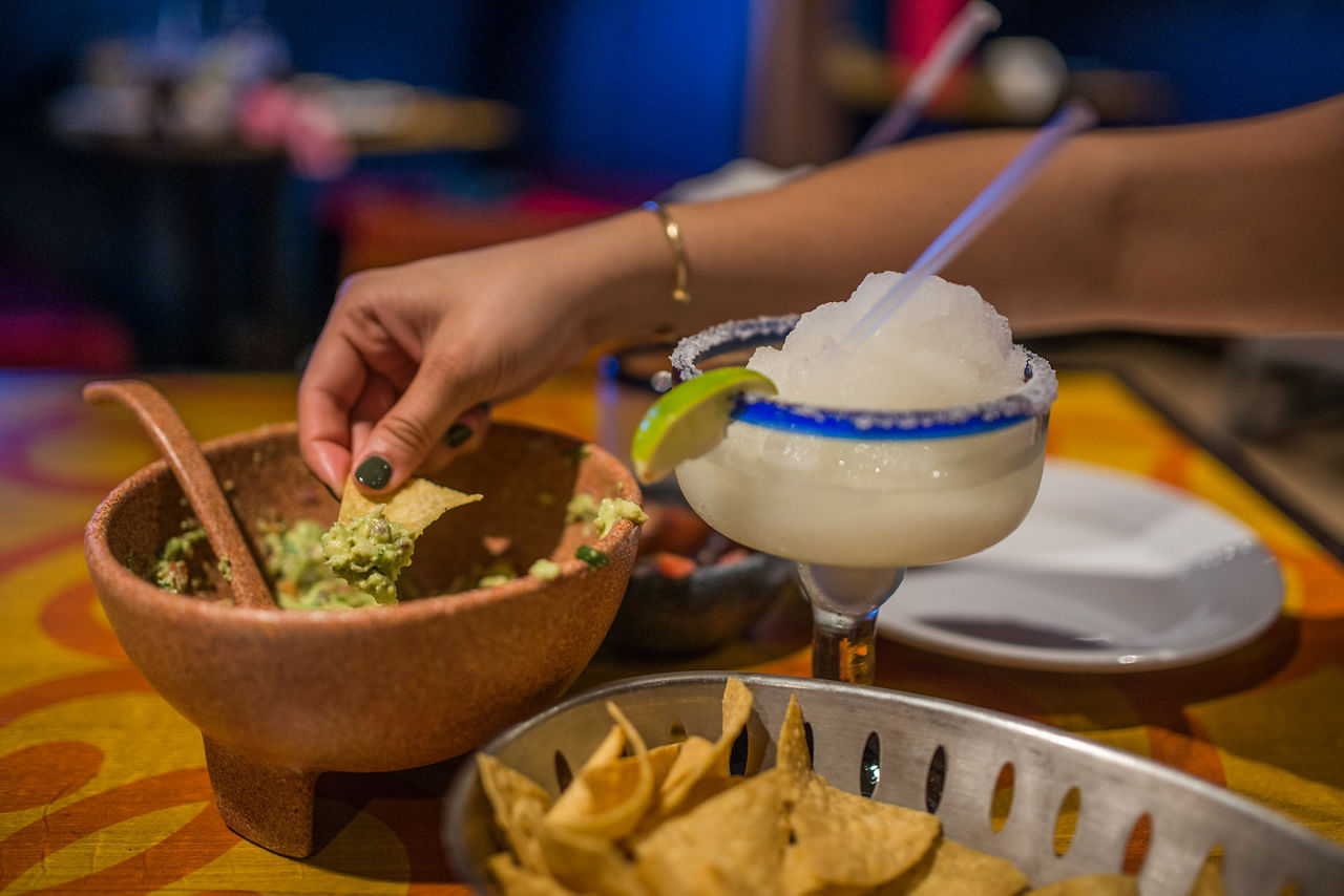 Woman Enjoying Guacamole and Margaritas