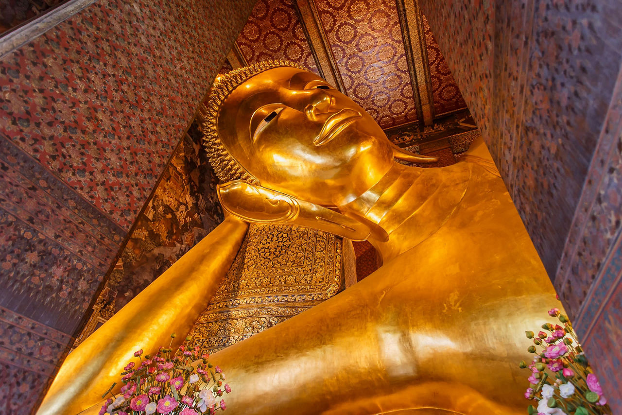 The reclining buddha gold statue face in Wat Pho Bangkok, Thailand