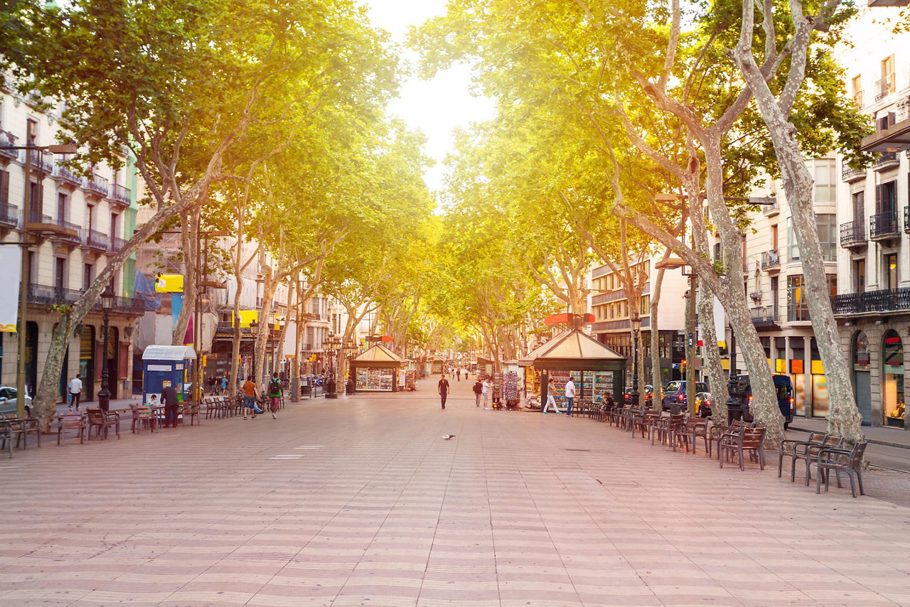 Street view of La Rambla in Barcelona, Spain, with shops lining the street