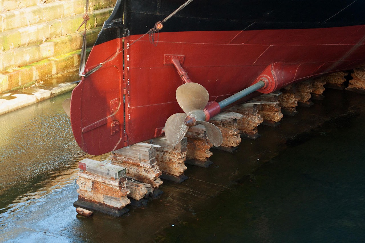 A vintage ship propeller and rudder