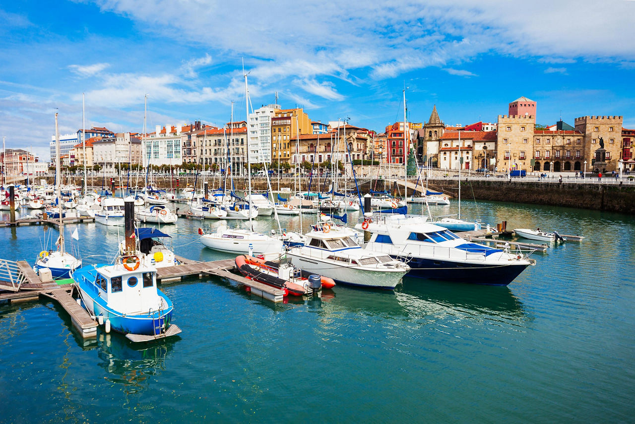 Boats docked at a marina in Gijon, Spain