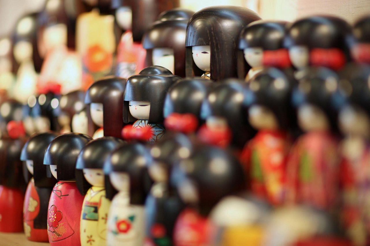 Traditional wooden japanese dolls sold in souvenir shops in Japan