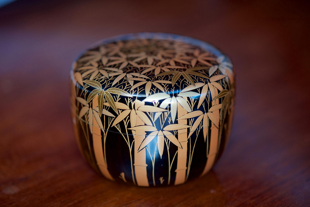 Vintage Japanese black lacquer tea caddy with auspicious gold makie bamboo forest design, used in the Japanese Tea Ceremony